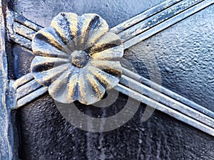 The fragment of forged metal products. close-up. Beautiful flower, handmade. Abstract background, texture, pattern