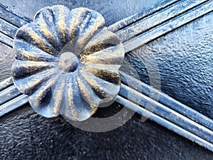 The fragment of forged metal products. close-up. Beautiful flower, handmade. Abstract background, texture, pattern