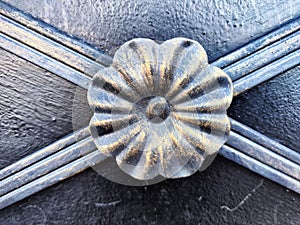 The fragment of forged metal products. close-up. Beautiful flower, handmade. Abstract background, texture, pattern