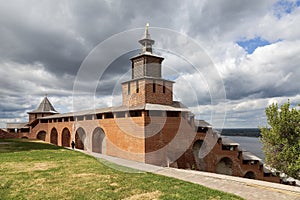 A fragment of the fortress wall of the Nizhny Novgorod Kremlin with the clock tower in the center and the North Tower in the dista