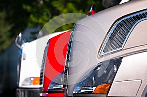 Fragment of front part of semi trucks Standing in row