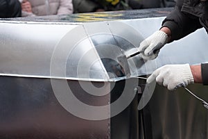 A fragment of the funeral ceremony, when the undertaker soldering zinc coffin