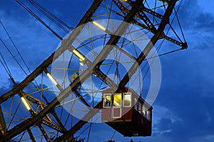 Fragment of giant ferris wheel under dramatic sky