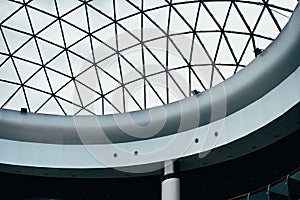 Fragment of glass dome made of metal triangular structures. Inside view from bottom