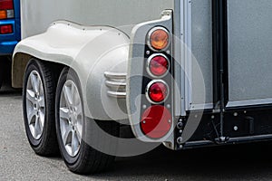 Fragment of a horse trailer for a car with wheels and taillights. Travel with animals