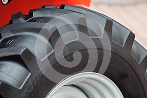 A fragment of a huge wheel and tire of construction equipment.