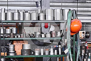 Fragment of industrial interior with a storage of metal products and tools in the workshop