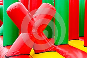Fragment of inflatable attractions in the form of a red letter X