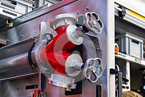 Fragment of the inside of a fire engine with valves for connecting water hoses.