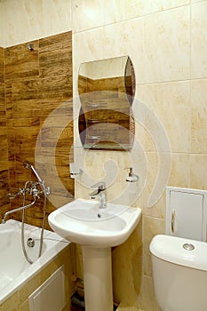 A fragment of the interior of the bathroom with a washroom and a mirror