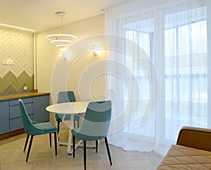 A fragment of the interior of the kitchen-dining room with wall lamps