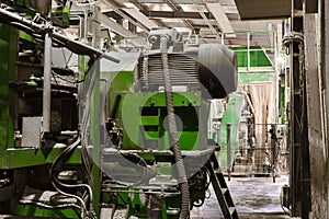 Fragment of the interior of the workshop of a modern sawmill with equipment covered with sawdust