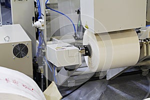 A fragment of a machine for the production of plastic bags