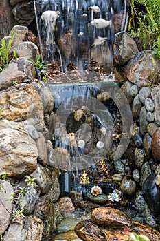 Fragment of man-made waterfall in the Park of the monastery Kopan, Kathmandu, Nepal.