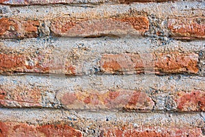 Fragment of masonry of an old red brick wall