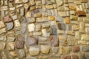 Fragment of medieval european road, wet cobblestone as background