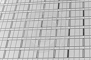 Fragment of a modern office building. Abstract geometric background. Part of the facade of a skyscraper with glass