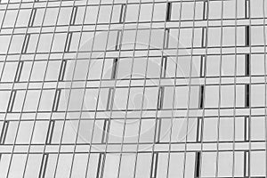 Fragment of a modern office building. Abstract geometric background. Part of the facade of a skyscraper with glass