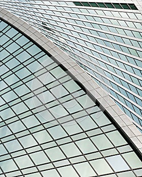 Fragment of a modern office building. Abstract geometric background. Part of a skyscraper with glass windows.