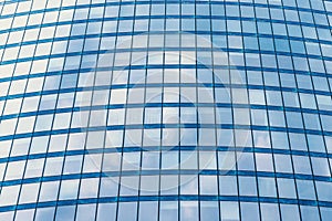 Fragment of a modern office building. Abstract geometric background. Part of a skyscraper with glass windows.