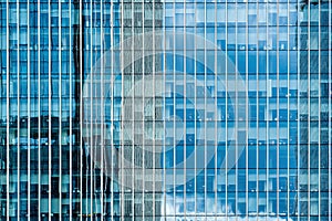 Fragment of a modern office building. Abstract geometric background. Part of a skyscraper with glass windows.