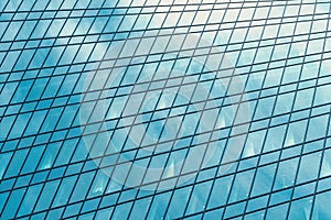 Fragment of a modern office building. Abstract geometric background. Part of a skyscraper with glass windows.