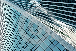 Fragment of a modern office building. Abstract geometric background. Part of a skyscraper with glass windows.