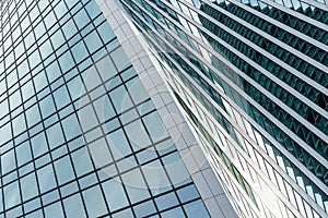 Fragment of a modern office building. Abstract geometric background. Part of a skyscraper with glass windows.