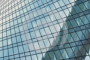 Fragment of a modern office building. Abstract geometric background. Part of a skyscraper with glass windows.