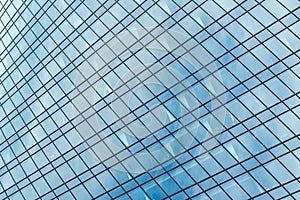 Fragment of a modern office building. Abstract geometric background. Part of a skyscraper with glass windows.