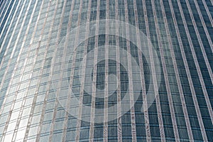 Fragment of a modern office building. Abstract geometric background. Part of a skyscraper with glass windows.