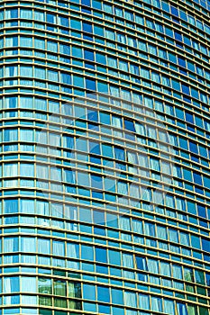 Fragment of a modern office building. Abstract geometric background. Part of a skyscraper with glass windows.