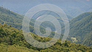 Fragment of the mountainous terrain in the Carpathians, Ukraine. The forest is forgiven by the reliefs of the Carpathian Mountains