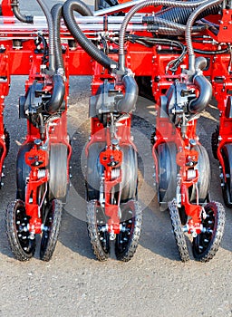 A fragment of a multi-row modern red seeder used in the agricultural sector