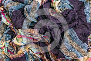 The fragment of multicolored fabric texture old scarf