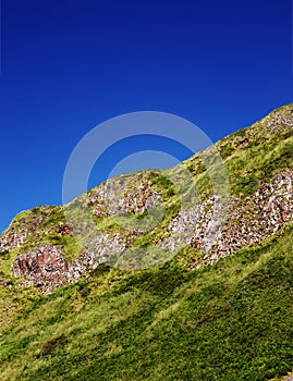 Fragment of a Northern Irish cliffs overgrown with grass