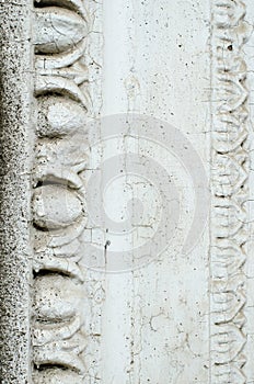 A fragment of an old building in classical style. White and grey. Background