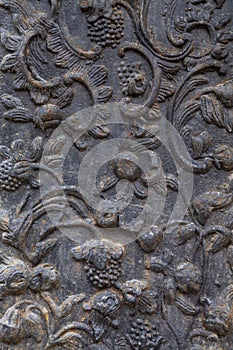 Fragment of an old cast-iron gate with a floral pattern