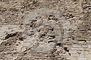 A fragment of an old fortress wall with traces of time and military operations.