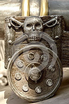 Fragment of an old gun carriage with a pirate emblem.