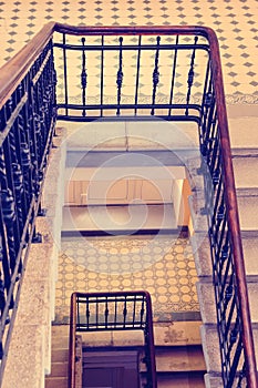 A fragment of an old marble staircase and a railing. Toning in the style of instagram