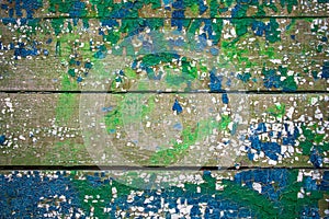 Fragment of an old painted multi-colored wooden wall. Wooden texture. Wooden fence.Texture, background.Mosaic surface