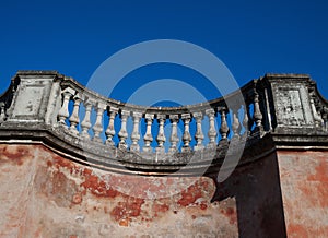 Fragment of old pink wall with balustrade