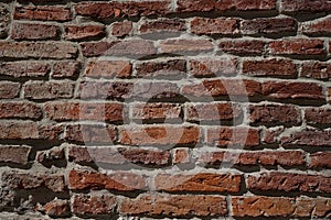 Fragment of old red brick wall.