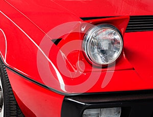 Fragment of an old red sports car close up