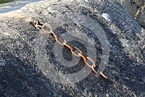 A fragment of the old rusted metal chain