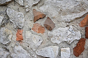 Fragment of old stone and brick wall