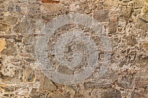 Fragment of old stone wall. Multicolored large cobbles. Old medieval castle stone wall texture background.