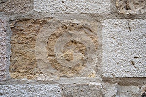 Fragment of old stone wall. Rough textured surface