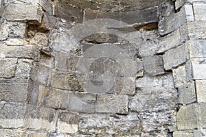 Fragment of the old wall, stone concave masonry